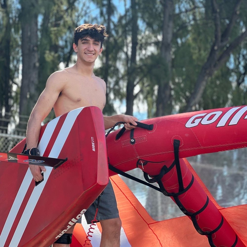 Wing foiling equipment and a rider at a Maui beach